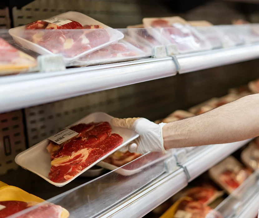 Packaged meat on display in grocery store.